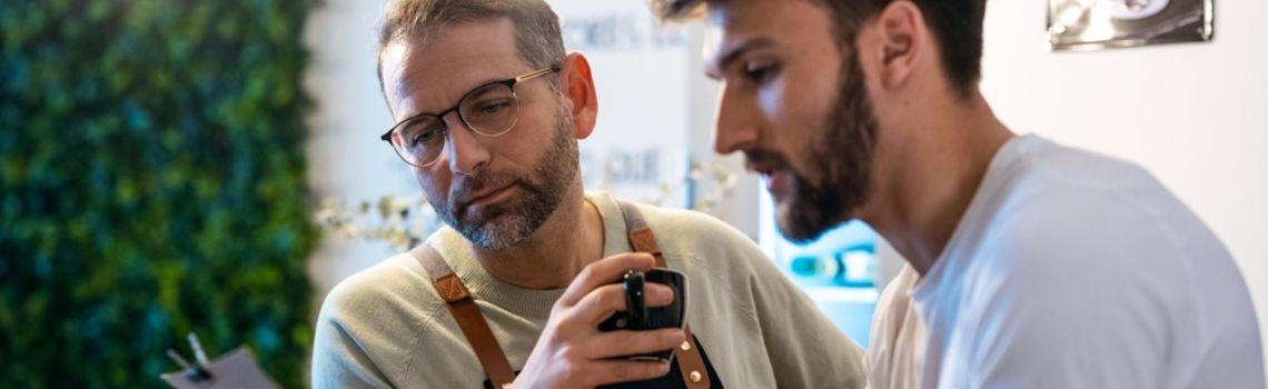 Two men talking with a cup of coffee