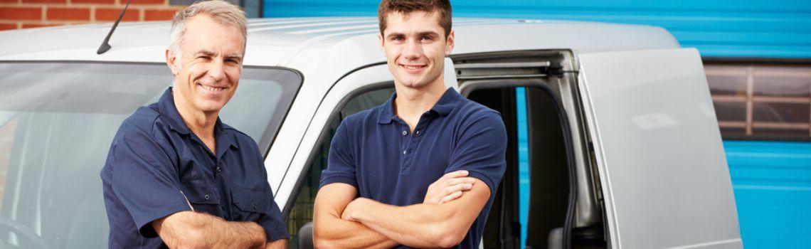 Two business men stood in front of a van